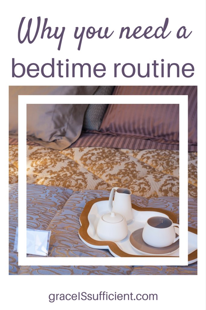 picture of a bed with a tray on top of the bed with a tea cup, sugar bowl, and milk pitcher